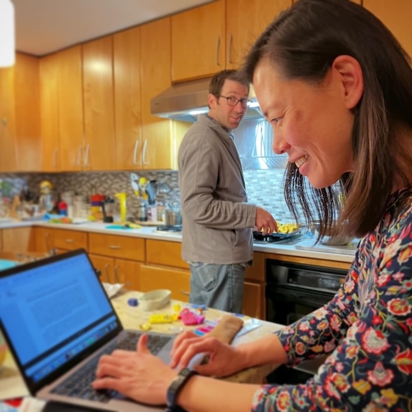 Author Rin-Rin Yu writing at the computer